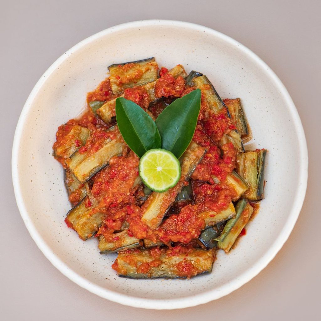 Eggplant and tomato vegan dish served at THIS IS BALI restaurant in Ubud, highlighting fresh flavors from one of the best restaurants in Ubud