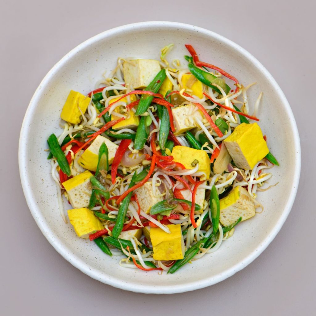 Sprouts and tofu dish served at THIS IS BALI restaurant in Ubud, offering a healthy plant-based option from one of the best restaurants in Ubud
