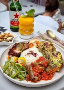 Traditional nasi campur served at THIS IS BALI Restaurant in Ubud with sambal, satay, and local sides